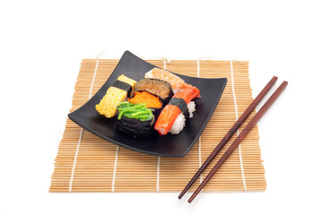 Sushi on black square plate, Asian food, Japanese. Isolated on background