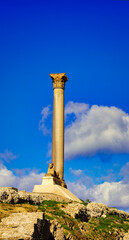 Close up of the majestic Pompey's Pillar,a Roman corinthian victory column built for the Roman emperor Diocletian in 302 AD at the Serapeum of Alexandria along with base sphinx in red granite 