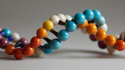 Colorful beads arranged in a double helix, symbolizing DNA structure.