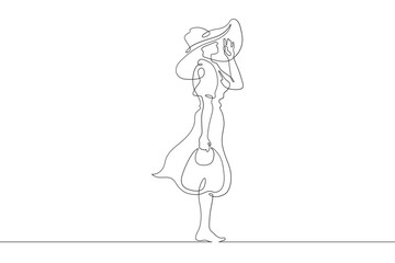 Woman on the beach in a big hat. Girl in a summer cape on the seashore.One continuous line. Line art. Minimum one line. White background. One line drawing.