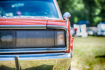 Classic American car on display at outdoor car show.