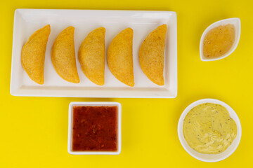 Delicious traditional Colombian empanadas with spicy sauce