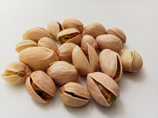 Pistachio nuts on white background.
