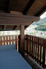 Wooden balcony terrace with Santa Maddalena Landscape view at Val di Funes, land of the pale mountains and beautiful valley in the Dolomites also one of UNESCO World Heritage site- South Tyrol, Italy