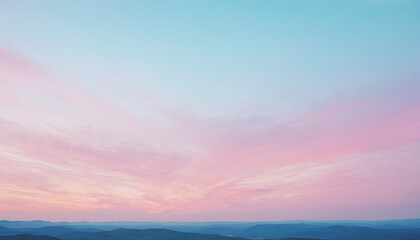 Fototapeta premium Soft pastel colors blend in the sky as clouds disperse over rolling hills during a tranquil evening, creating a peaceful atmosphere at dusk