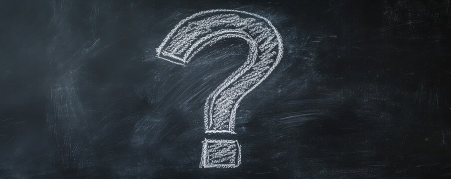 A chalk question mark on a blackboard representing uncertainty and curiosity in education or communication.