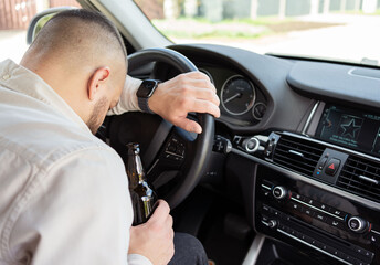 Man drinking alcohol while driving a car. Don't drink and drive concept