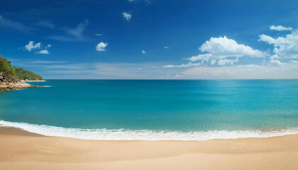 The wide sea and the sandy beach. Blue sky.