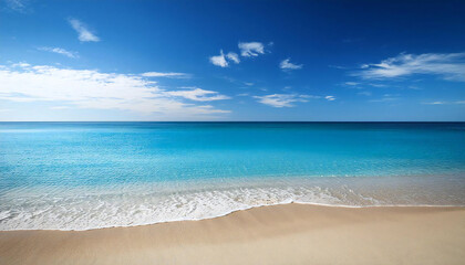 The wide sea and the sandy beach. Blue sky.