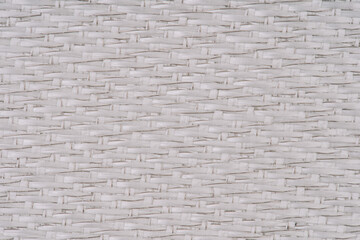 Close-up of white woven fabric with visible metal threads, featuring a detailed and intricate pattern. The image has a soft focus with a textured surface.