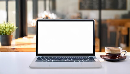 Notebook laptop white screen mockup is on a white table in simple minimal coffee shop
