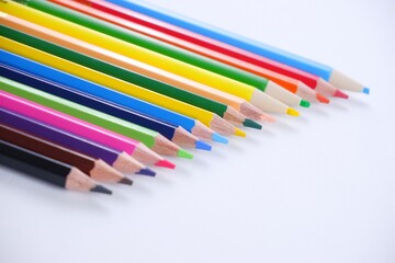 Wooden colored pencils and paper isolated on white backdrop with copy space image.