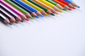 Colorful wooden colored pencils isolated on white backdrop with copy space image.