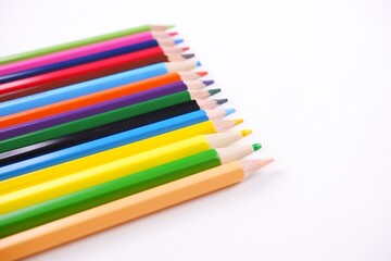Wooden colored pencils and paper isolated on white backdrop with copy space image.