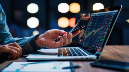 Close-up of a hand holding a mobile phone in front of a laptop. Work media, doing business, using technology for financial transactions or shopping, making various contracts.