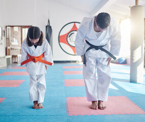 Child, teacher or bow in dojo for martial arts, training or exercise to prepare for karate education. Respect, warrior or judo master with girl kid in studio ready for taekwondo practice or workout © Fanti/peopleimages.com