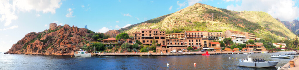Panoramic view of the marina of Porto in Corsica, topped by a Genoese tower, is one of the gateways to the Scandola reserve and the Piana calanques, both listed as UNESCO world heritage sites