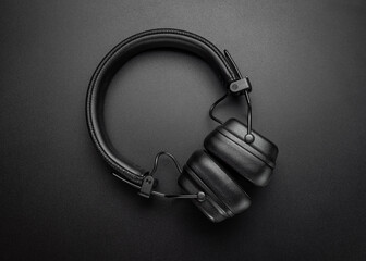 Full-size headphones. Modern devices for listening to music, black background. Studio shot.