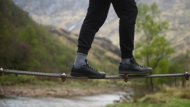 Man walking on a rope cable tightrope walker Scotland 4k