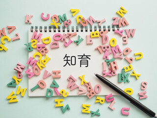 ノートに知育の文字とたくさんのアルファベット
