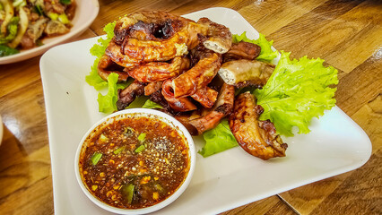 Grilled pork intestines. Grilled intestines, Roasted pork Chitterlings (Sai-On Yang) with spicy sauce. Traditional and local Thai food. Thai north-eastern people. Street food, Beer appetizer