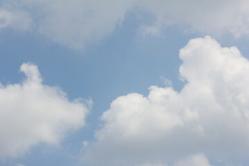 A blue sky with puffy clouds.