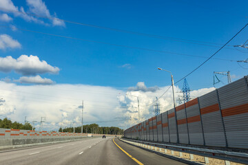 A highway with a blue sky and a few clouds