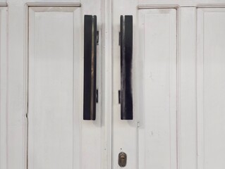 The background of the door is made of white wood 