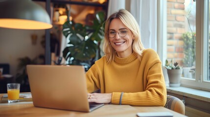 Fototapeta premium A beautiful professional woman uses a laptop in a modern office