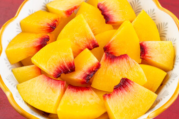 A plate of fresh yellow peach slices