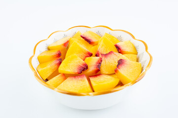 A plate of fresh yellow peach slices