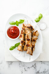 Traditional meat skewers with ketchup