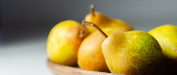 A basket of pears with a few of them still attached to their stems