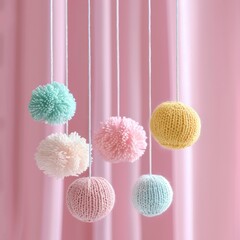 Baby crib mobile balls on pink background, knitted toy for children, hanging knitted balls
