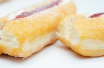 A jelly donut with a jelly filling and a powdered sugar topping