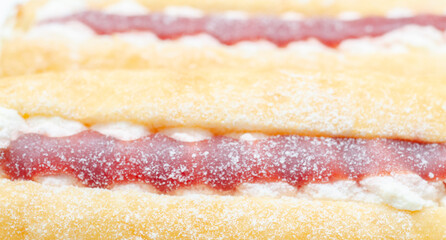 A jelly donut with a jelly filling and a powdered sugar topping