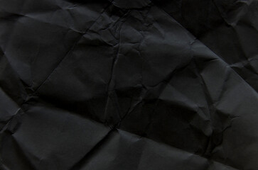 crumpled torn and old black paper