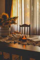 Open Bible, burning candle, sunflowers in a cozy home atmosphere
