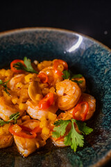 dish with shrimps on dark background
