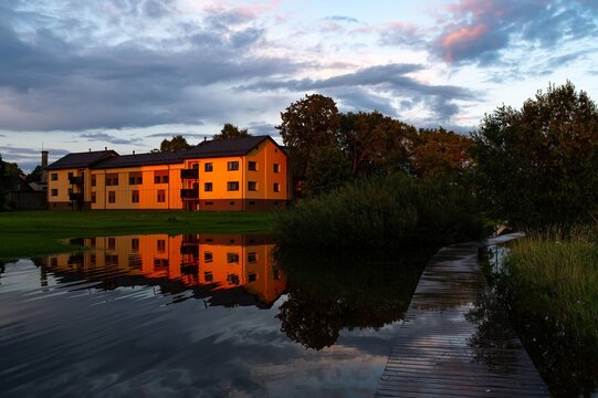 Modern House in Estonia, V&otilde;ru at Sunset Light with Flooded Trail by a Lake. National Sunset Day. World Refugee Day. International Migrants Day