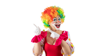 Funny female clown pointing at blank template copy spase for advertising, posters, greetings, invitations. Entertainer as Joker in a suit and wig, with clown whiteface makeup.