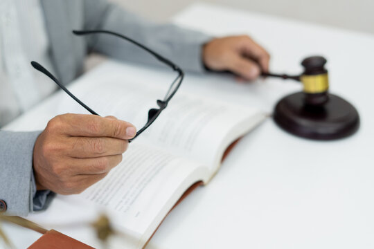 university student prepares for exams in a library, engrossed in legal studies with books and glasses, dedicated to gaining knowledge and academic success..