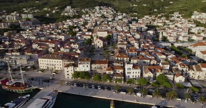 Fly Back Over Makarska Port Town On The Adriatic Coastline Of Croatia. Aerial Pullback Shot