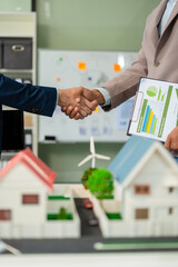 Businessmen shake hands after agreeing to start a new project successfully, renewable and...