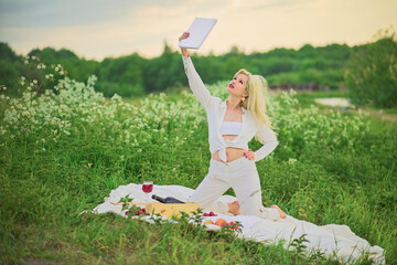 A woman is inspired by reading a book in nature. Concept.
