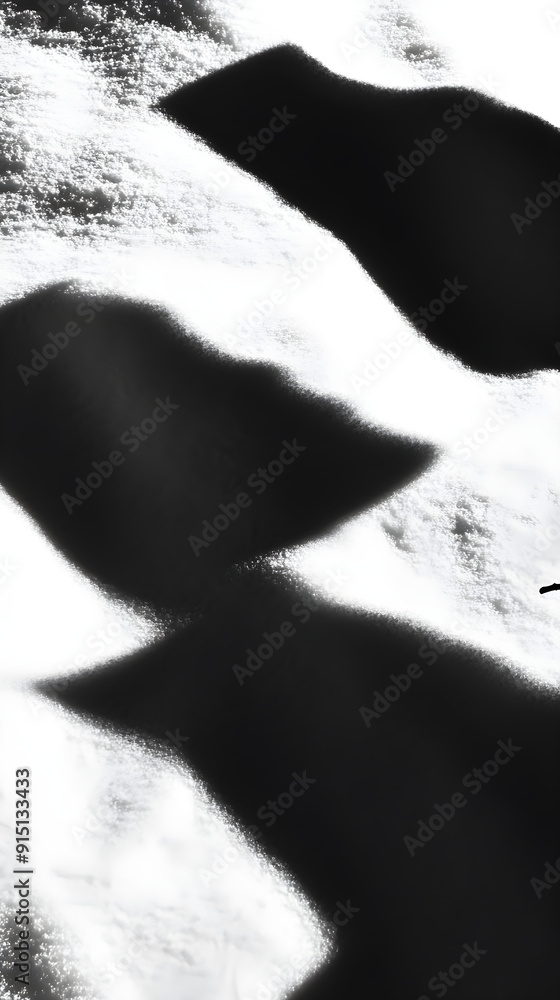Poster shadows of abstract shapes blend softly on a textured surface creating a sense of mystery and intrig