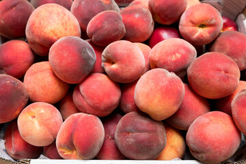 Ripe and juicy peaches in a box