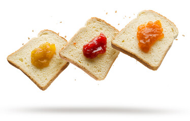 Slices of white bread with variety of jam flying on white background.