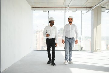 Indian and African American engineers at construction site