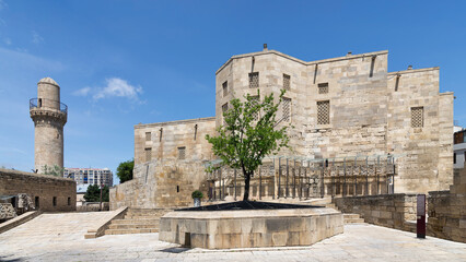 The historical Palace of the Shirvanshahs stands majestically in the Old City of Baku, Azerbaijan, showcasing intricate stonework under a vibrant blue sky